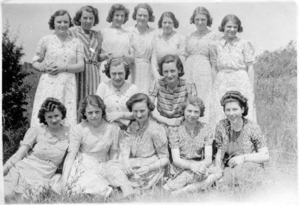 Fourteen young women posing in a field. They probably worked for Phipps, c.1940 © High Wycombe Museum