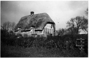 monochrome image of a thatched cottage
