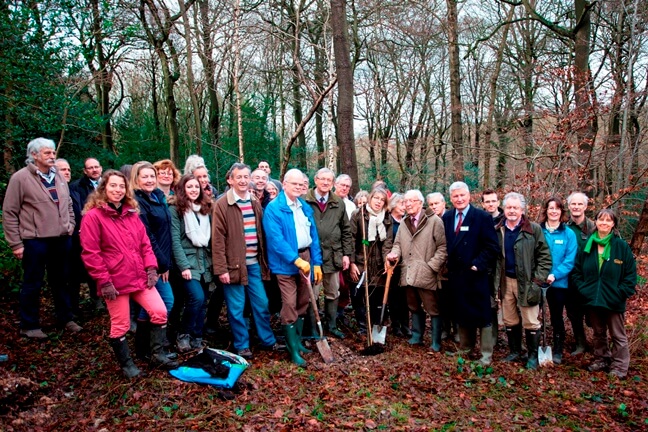 Board and Staff planting a tree