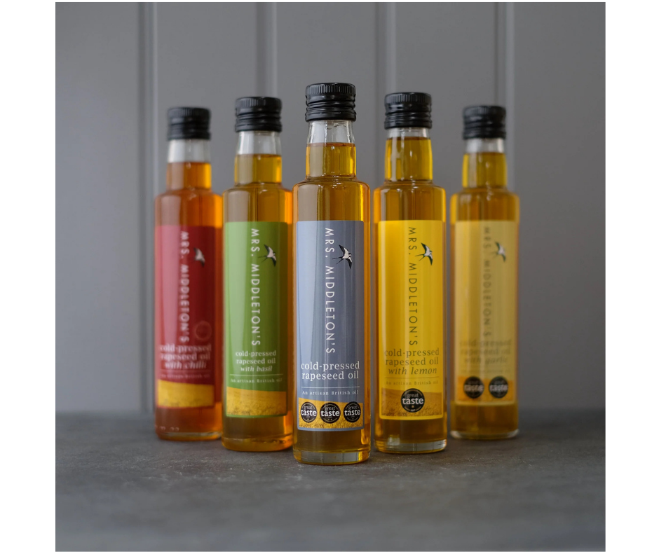 5 bottles of oil each with a different coloured label.