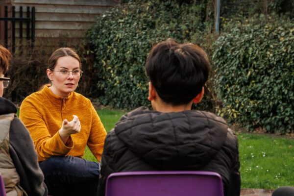 young staff member working with group of young people