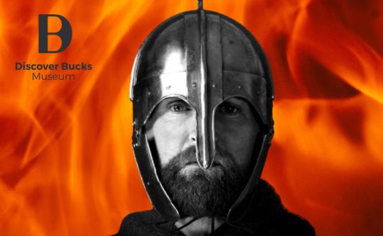 Picture of a Saxon in full armour with a fire background